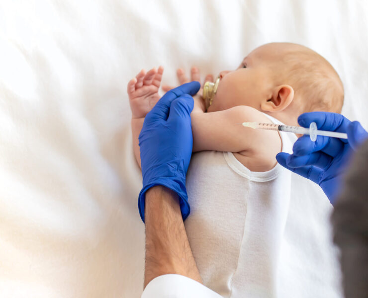 Vaccination baby, injection in the arm. Selective focus. People.